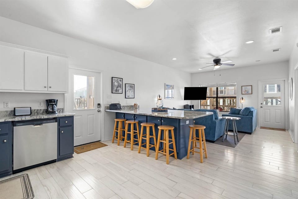 Your spacious open-concept living area seamlessly blends cooking and relaxation with a stunning kitchen island and cozy seating.