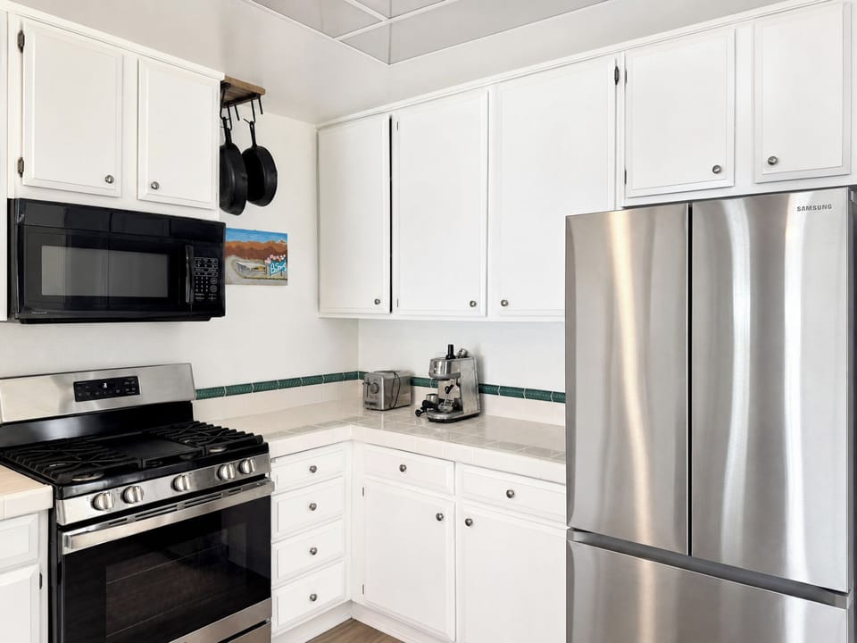 Step into a fully equipped kitchen ready for your culinary adventures. With modern stainless steel appliances, ample counter space, and everything you need to whip up your favorite meals, you'll feel right at home preparing breakfast or gathering for dinne