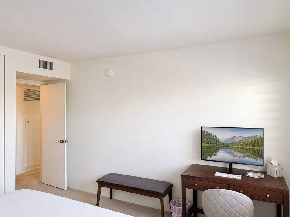 Your bright bedroom offers comfortable furnishings, climate control, and modern entertainment with a wall-mounted flat-screen television for your relaxation and enjoyment.