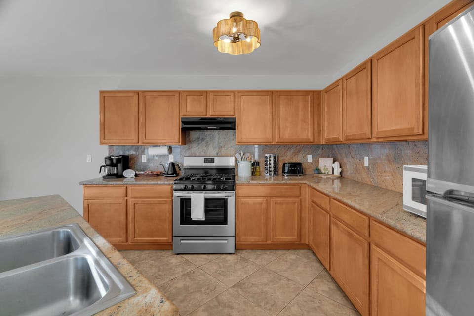 Cook with ease in this well-stocked kitchen featuring full-size appliances and ample workspace.