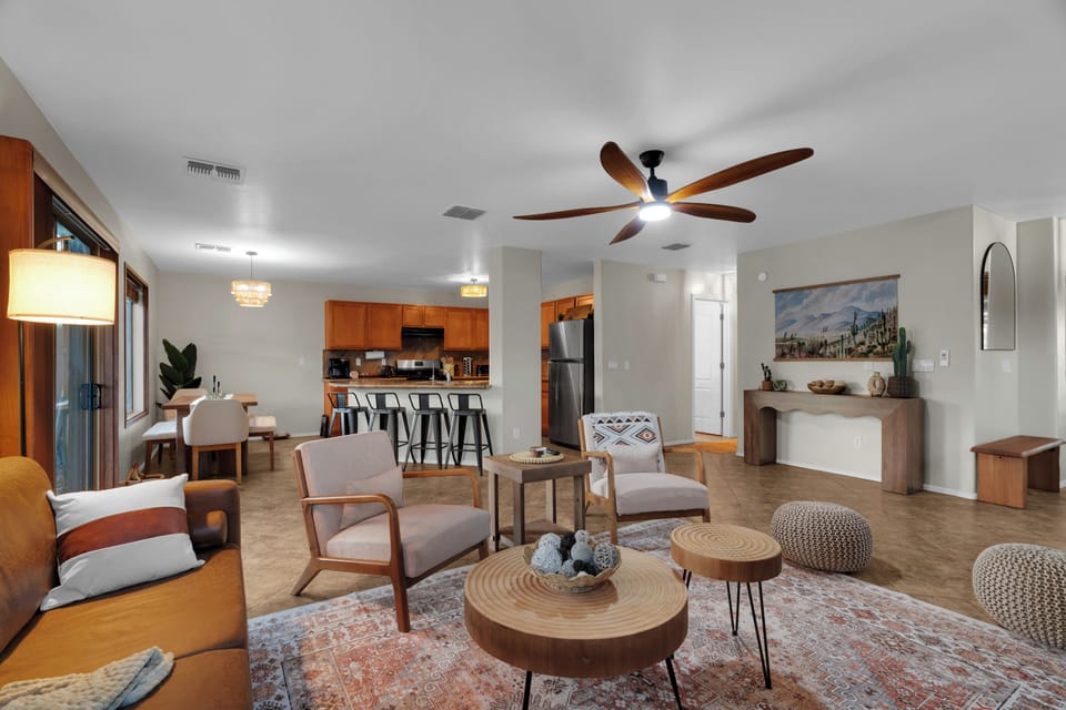 Bright, open living space with comfortable seating, stylish decor, and seamless flow into the kitchen—perfect for relaxing or gathering with your group.