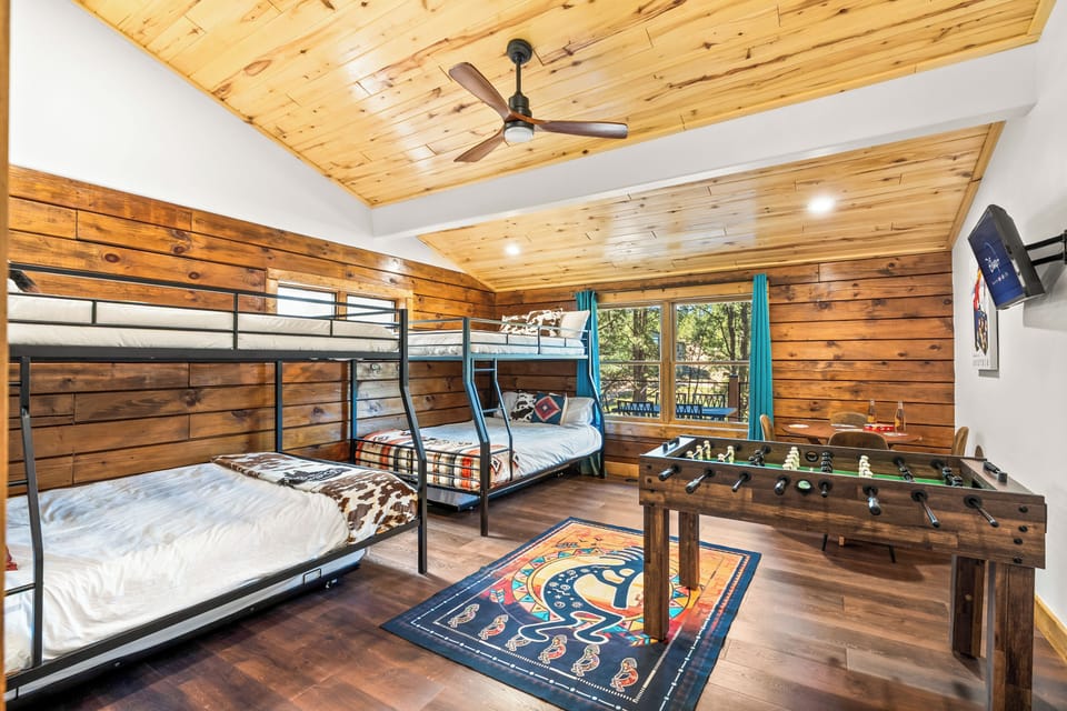 Spacious bunk room features oversized custom bunks, a foosball table, & games!