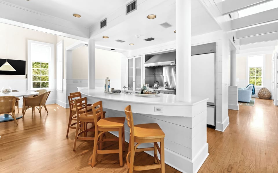 Enjoy meals at the breakfast bar, cook together with modern appliances, and feel the coastal light streaming through generous windows.