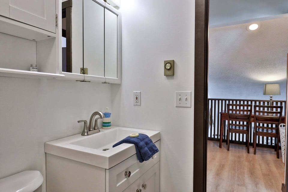 Just outside the bathroom, the loft landing has a table and chairs by the railing.