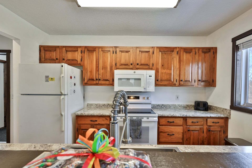 Appliances and cabinet storage sit together across from the kitchen sink.
