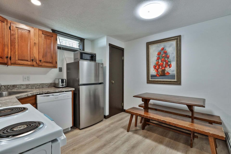 Bench seating sits just beside the kitchen for casual meals.