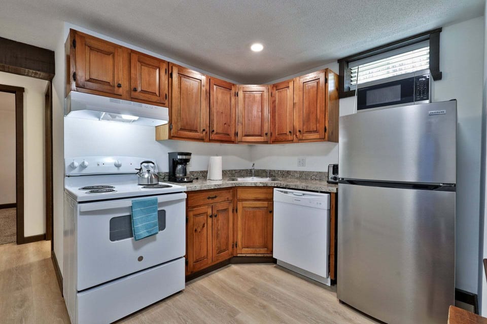Cooking essentials sit close by, including a range, refrigerator, dishwasher, microwave, and coffee maker.