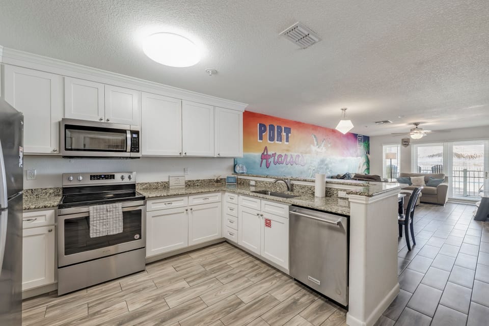 Your fully equipped kitchen features granite countertops, modern stainless steel appliances, and opens to a bright living space—perfect for gathering with loved ones.