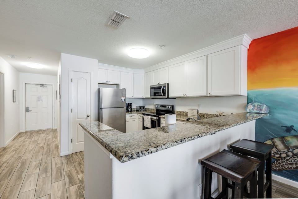 Your fully equipped kitchen features granite countertops, stainless-steel appliances, and breakfast bar seating—perfect for cooking and gathering with loved ones.