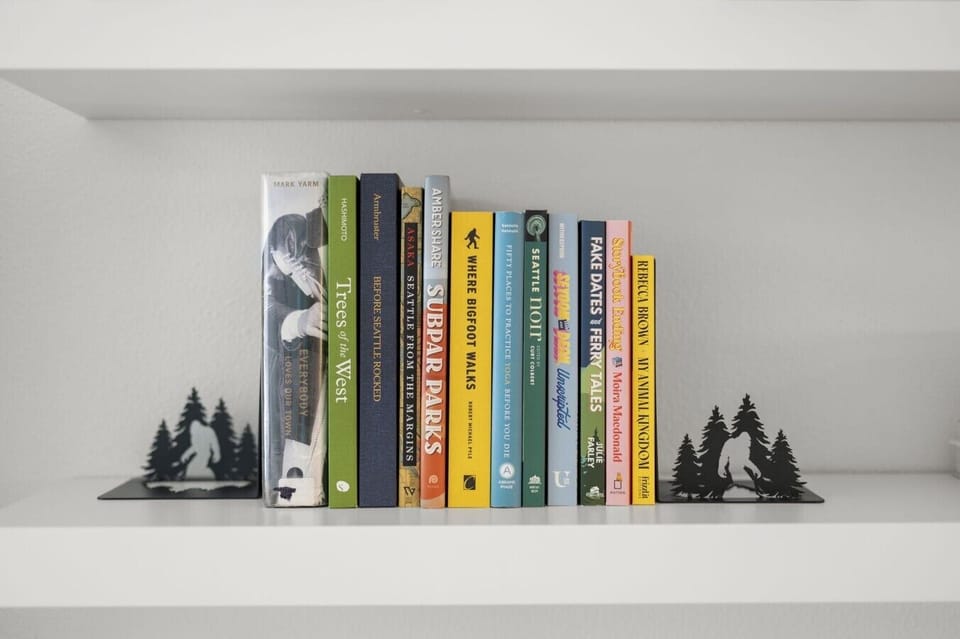 Built-in bookshelf with curated books and Pacific Northwest-inspired décor, adding character and a personal touch to the living space.