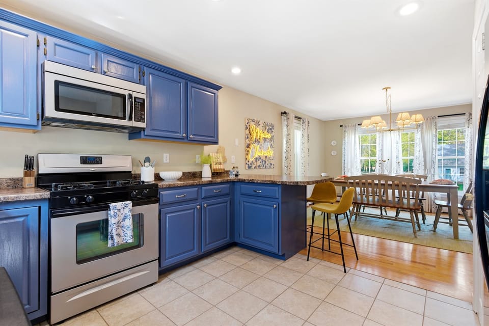 A bright and open kitchen featuring a stylish island and an adjacent dining area, designed for effortless cooking, dining, and gathering with family and friends.