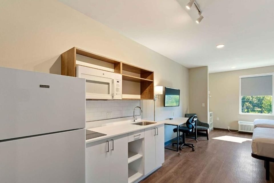 Cook simple meals with a sleek kitchenette and full fridge.