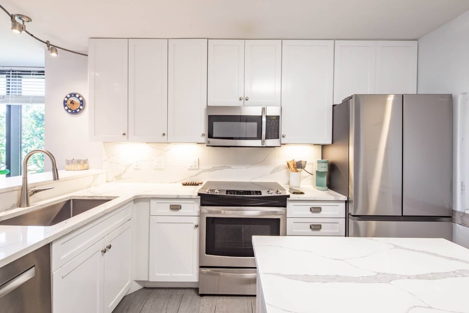The kitchen features a dishwasher, electric range, microwave and refrigerator.