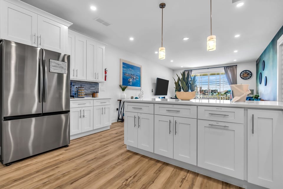 Bright modern kitchen with large island and stainless steel appliances