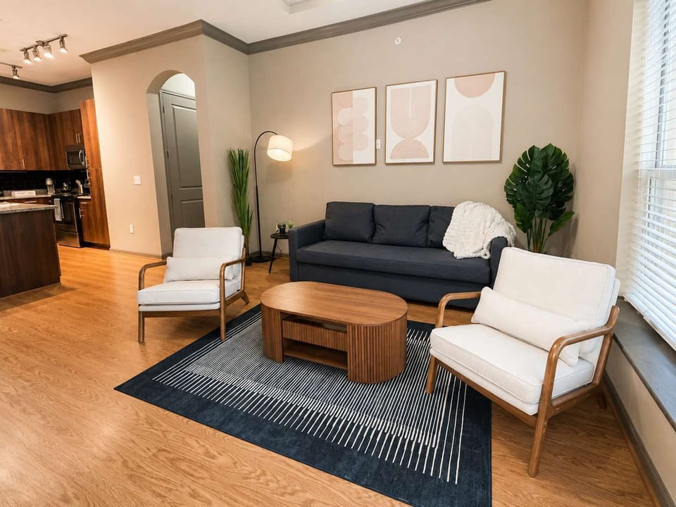 Warm, stylish living room with modern seating, cozy lighting, wood accents, and a clean, inviting layout.