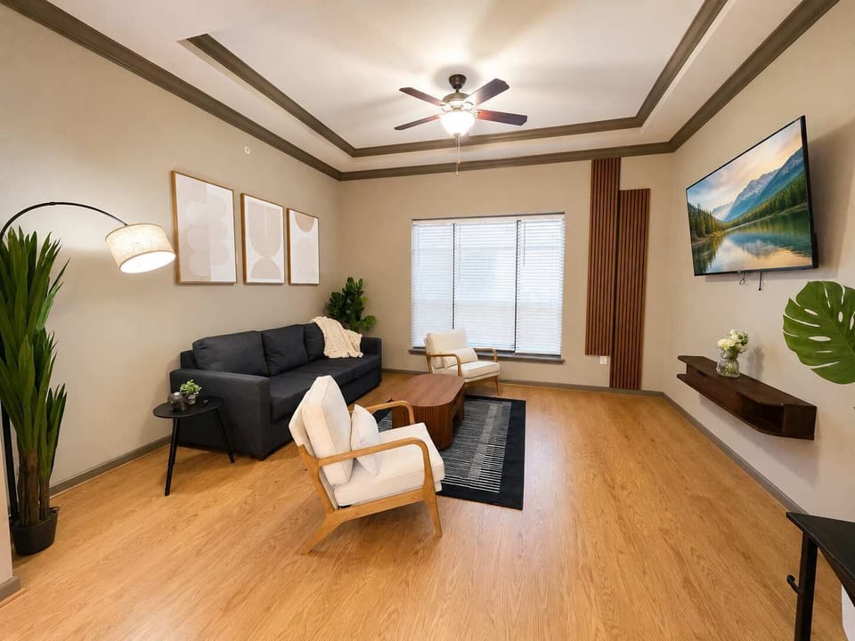 Warm, stylish living room with modern seating, cozy lighting, wood accents, and a clean, inviting layout.
