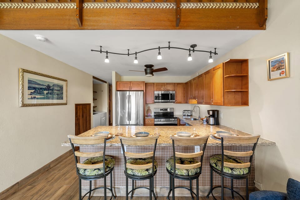 Dining area with large table and open kitchen perfect for group meals.