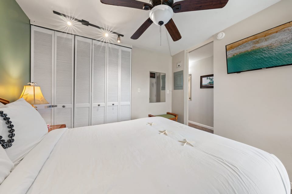 A functional bedroom with a queen bed, storage, and a bright, open feel.