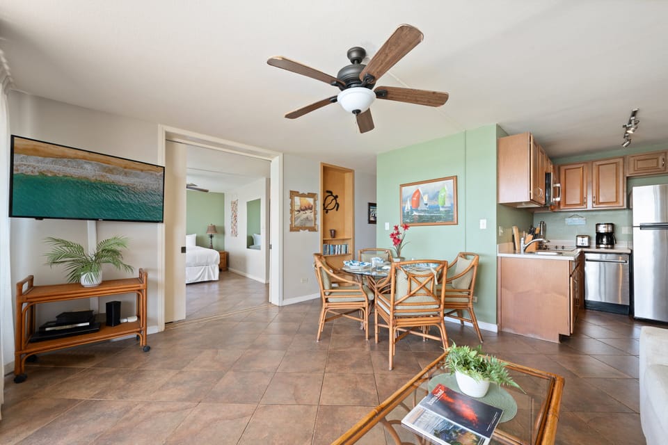 Open layout connecting the living room, dining area, and fully equipped kitchen.