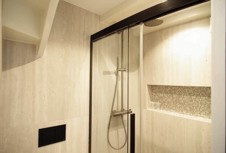 Walk-in shower with clean lines and soft lighting for a spa-like feel.