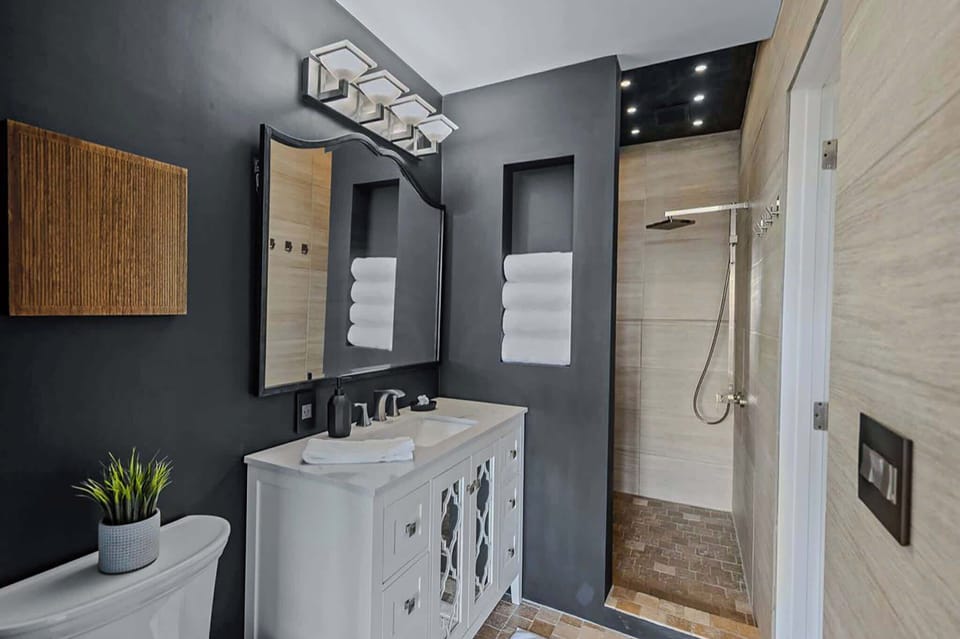 The shared ensuite features a single vanity & walk-in shower​