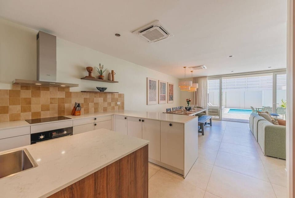Modern open plan kitchen and lounge with bright natural light and stylish finishes.