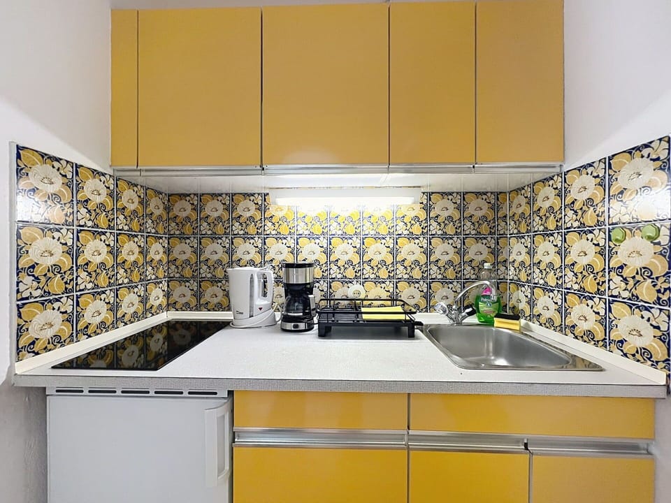 Yellow, Kitchen, Flooring, Countertop, Interior Design, Kitchen Appliance, Tile, Floor, Major Appliance, Kitchen Sink