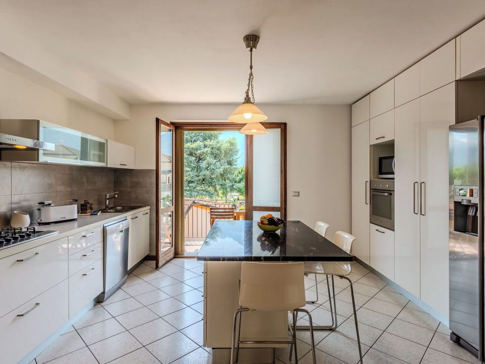 Furniture, Interior Design, Flooring, Kitchen, Countertop, Floor, Wood, Chair, Kitchen Appliance, Kitchen & Dining Room Table