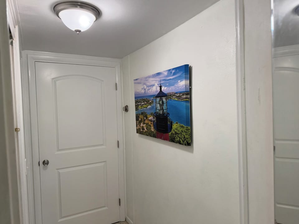 hallway from bedroom to bathroom (left). Door in view is the lock-out to owners.