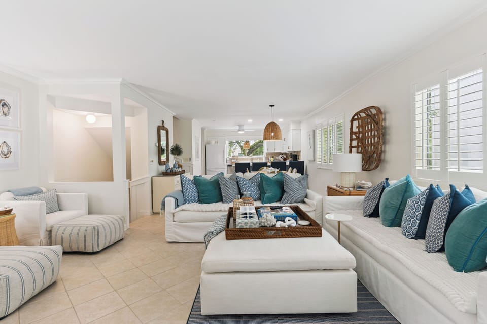 Sink into plush coastal comfort in this bright, open-concept living space where soft whites and ocean blues invite you to unwind in style.