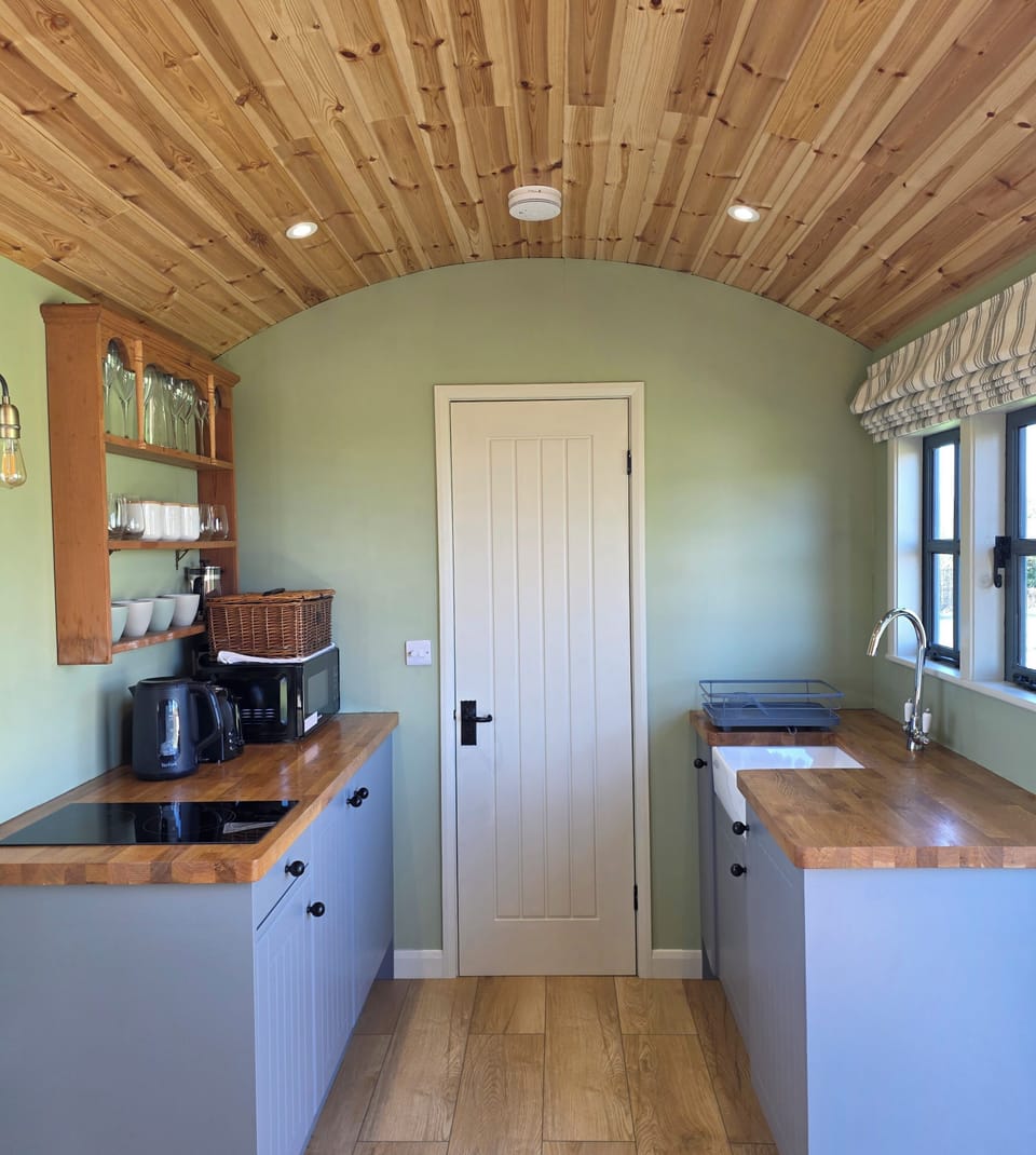 Kitchenette with microwave, kettle, toaster, induction hob and belfast sink