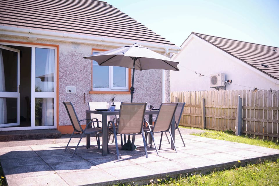 Enjoy a sunny patio space with outdoor seating, perfect for family meals or morning coffee.