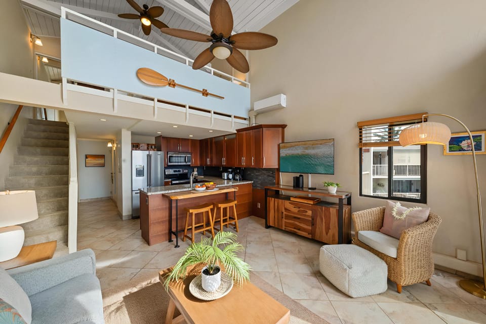 Spacious open-concept interior with kitchen, dining, and loft above.