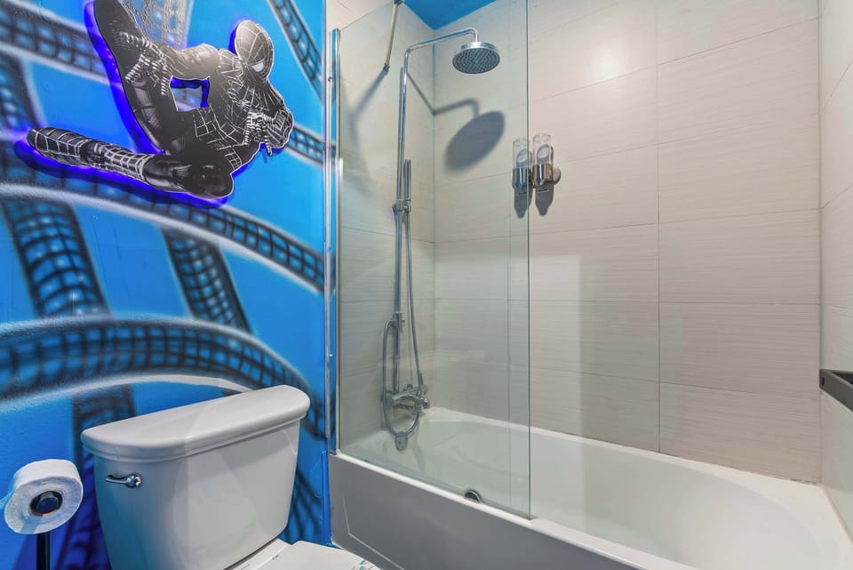 Modern bathroom with a shower and a unique spiderman mural for a playful atmosphere