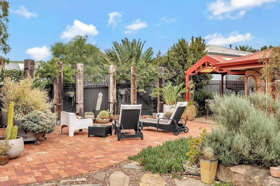 Step outside into a landscaped courtyard with native plantings and relaxed outdoor seating, creating a peaceful setting to unwind and enjoy the fresh coastal air.