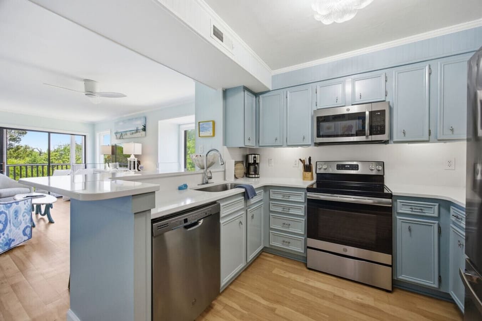 Enjoy easy vacation meals in this fresh beach-inspired kitchen with ample counter space