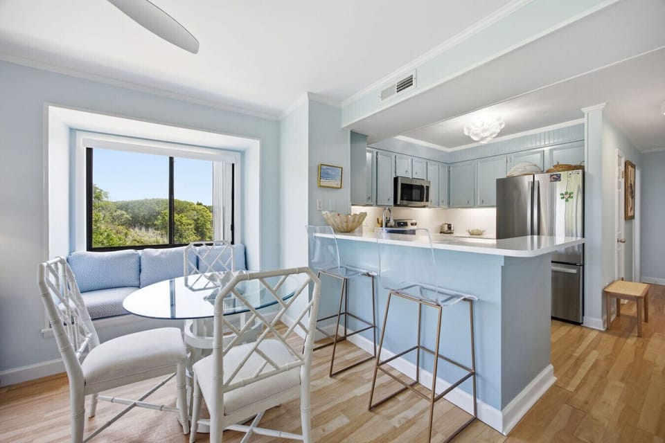 Share meals, laughs, and beach-day plans in this fresh open-concept dining space