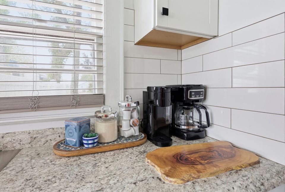 Start your mornings with fresh coffee in this thoughtfully stocked kitchen space