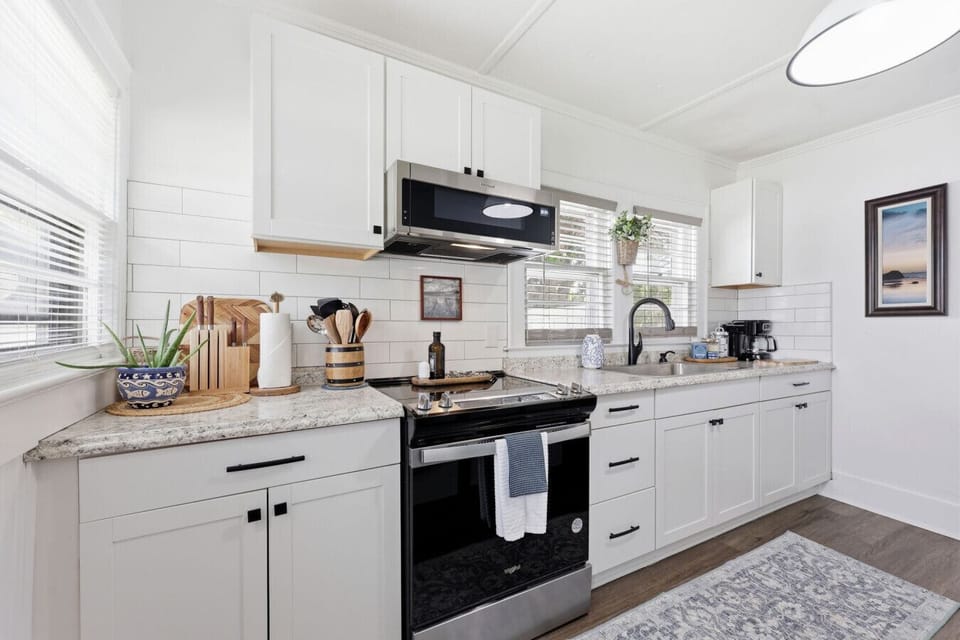 Fully equipped kitchen with clean coastal design and modern conveniences