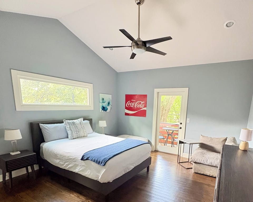 Upstairs Queen with plush bed and balcony