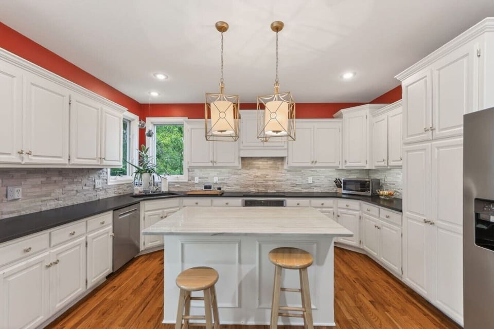 Bright, fully equipped kitchen with ample cabinet storage for your convenience.