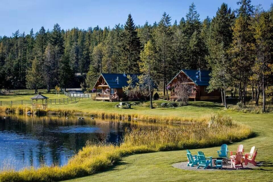 Pond, fire pit and cabin in the background. 