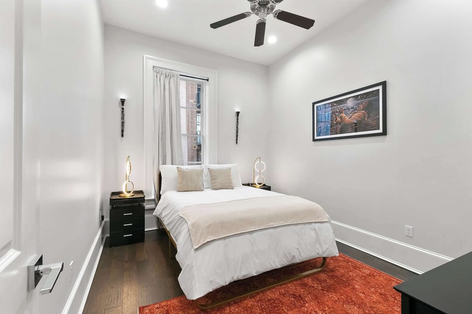 Queen room featuring real instruments mounted as art and a monumental Kalli Padgette painting honoring Katrina and New Orleans culture. Soaring ceilings, sunlit angles, and gallery-worthy views create a one-of-a-kind stay.