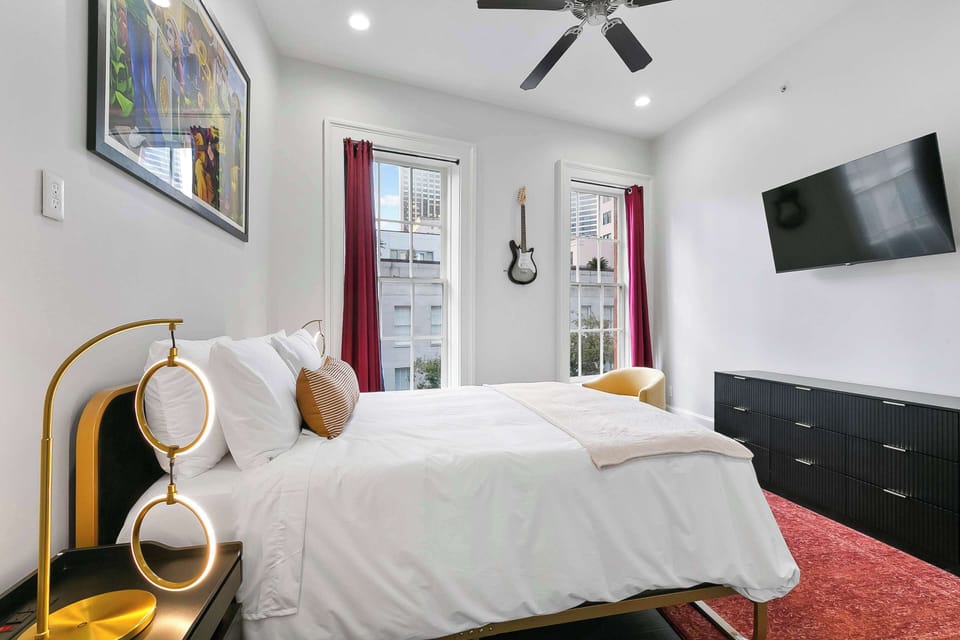 Cozy New Orleans retreat with striking local artwork, plush bedding, hardwood floors, and modern comforts for a relaxing stay.