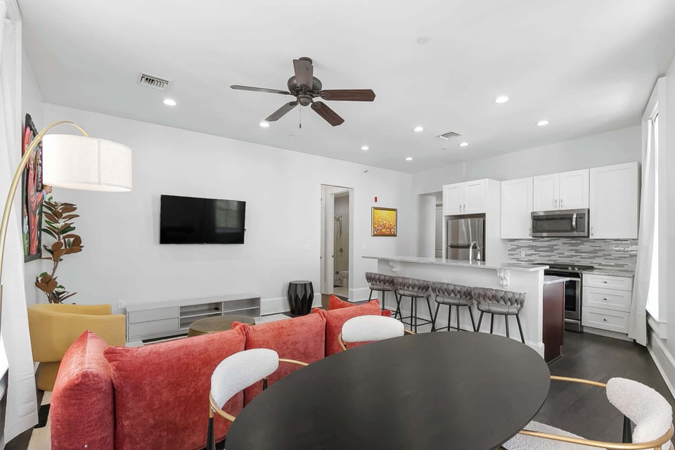 Art-forward lounge featuring bold 3D artwork by Patrick Henry, cozy seating, and an open design blending modern comfort with New Orleans style.