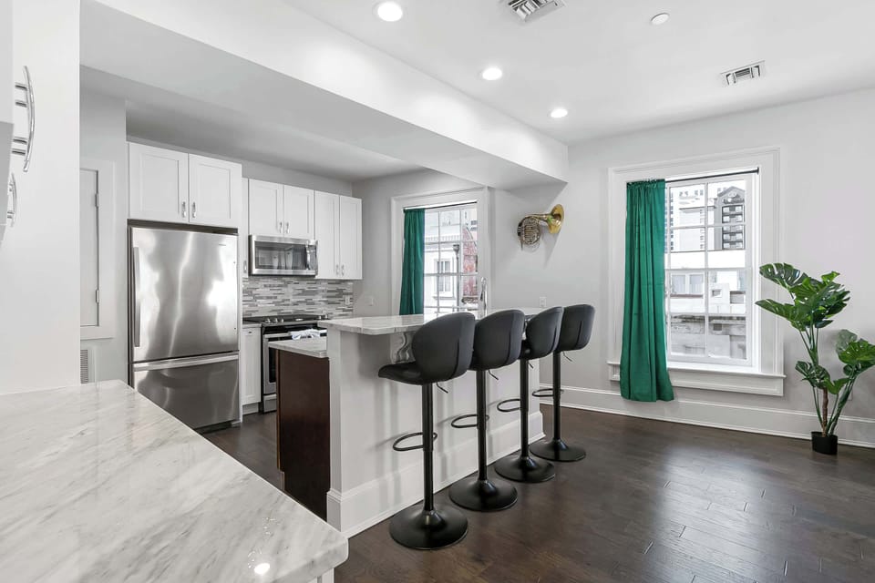 Fully renovated kitchen stocked with everything needed for casual meals or entertaining, including stainless appliances, full oven, microwave, Keurig coffee maker, cookware, dishes, utensils, spices, and cleaning supplies.