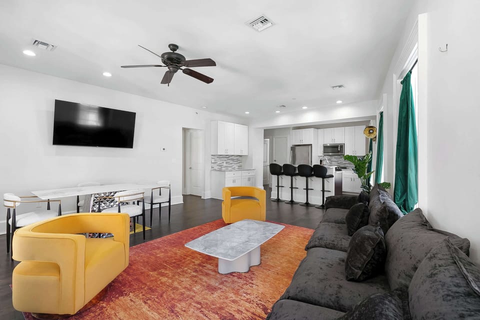 Funk Room featuring walls decorated with bold local artwork, cozy lounge seating, soaring ceilings, and vibrant New Orleans-inspired style.