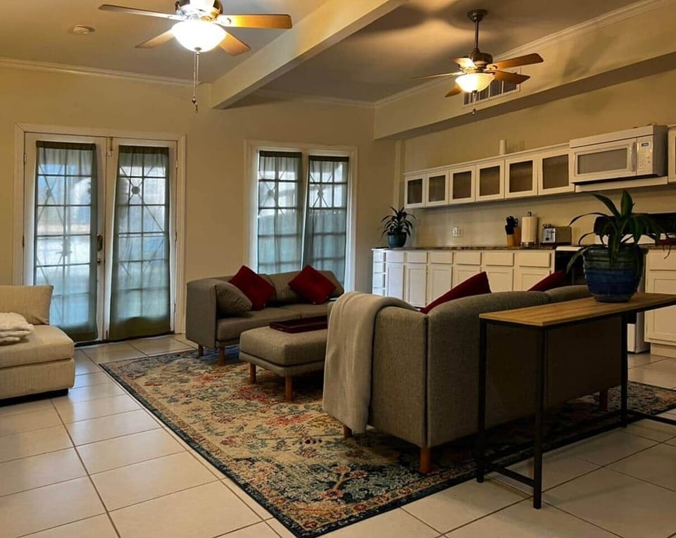Well lit living room with comfortable seating.