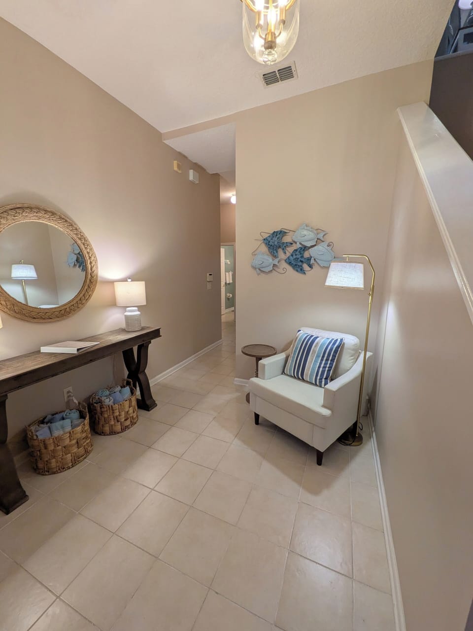 Bright coastal-inspired entry with cozy seating and elegant décor