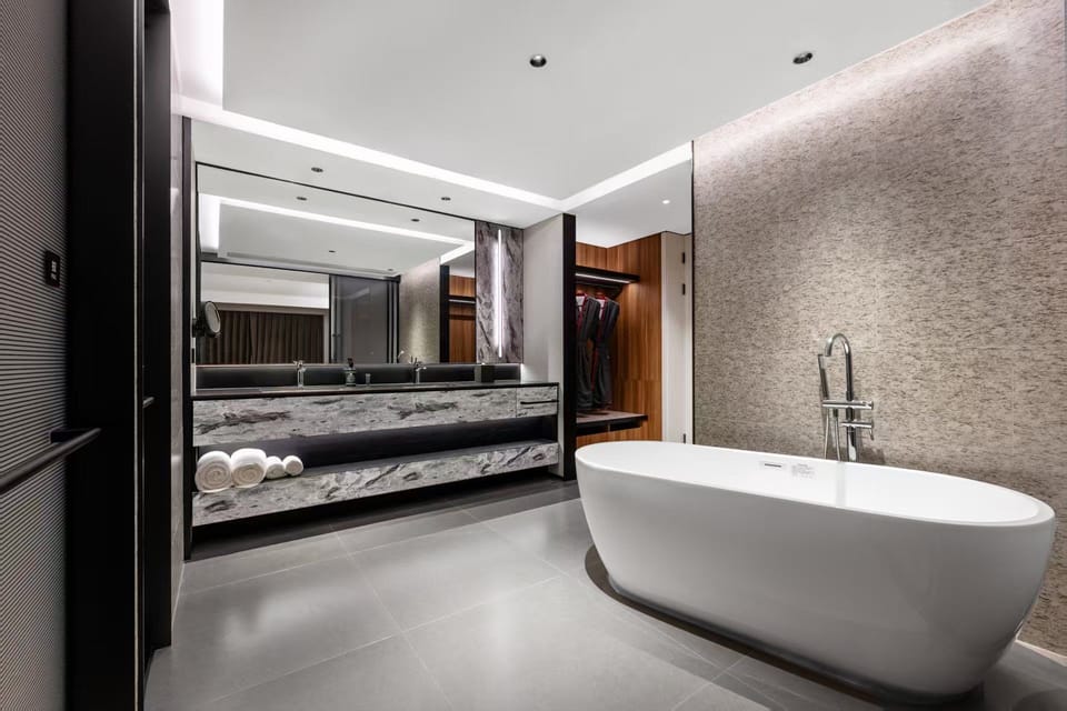 Business Suite, 1 Queen Bed, Hot Tub, City View | Bathroom | Separate tub and shower, hydromassage showerhead, designer toiletries